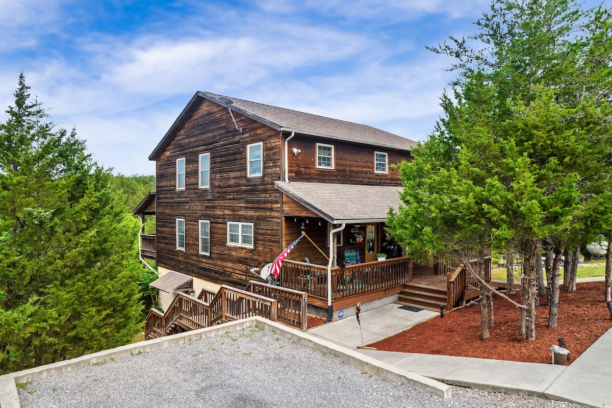 Cedar log cabin exterior surrounded by trees